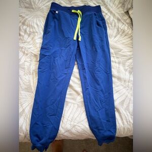 Figs Blue joggers
Has a small bleach stain on the left side